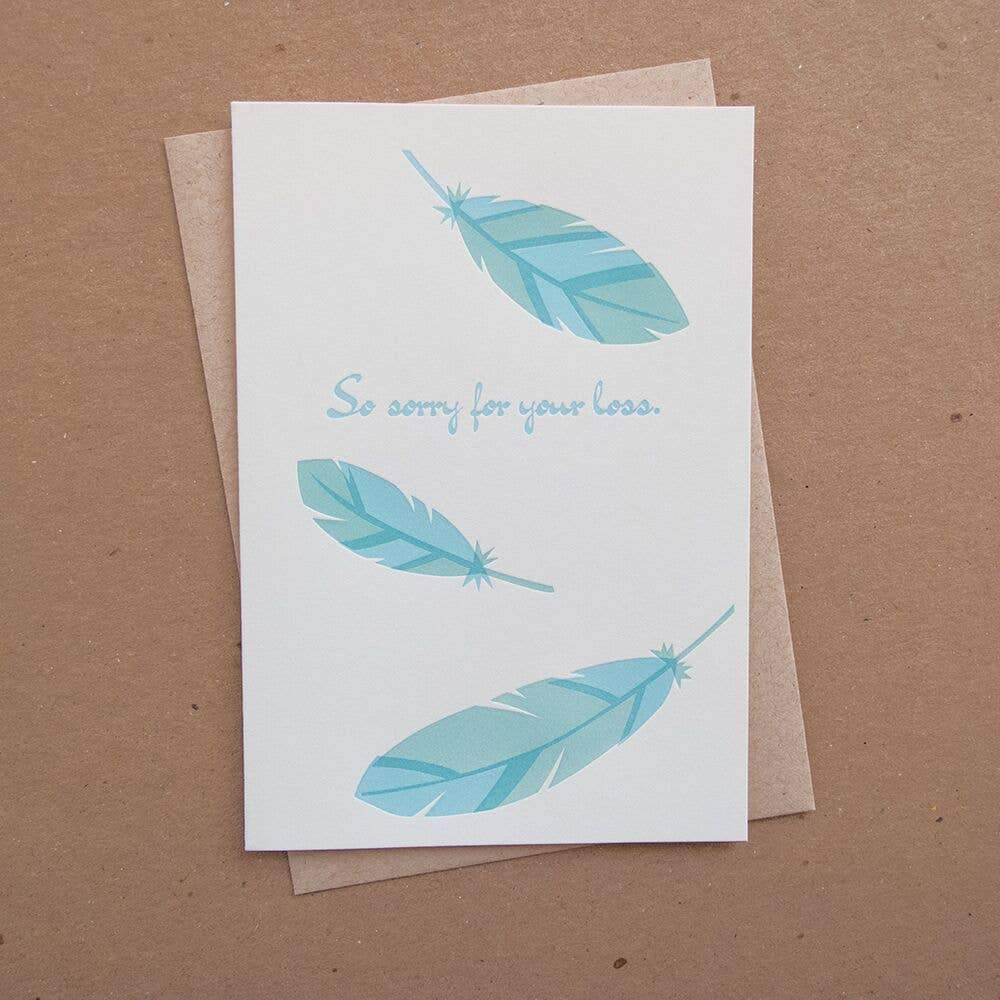 Letterpress sympathy card with blue feathers and so sorry for your loss text