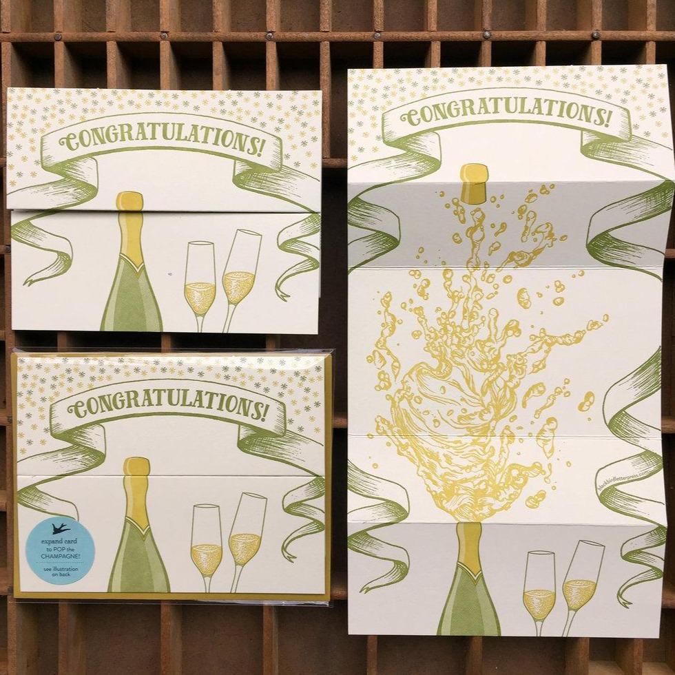 Green and yellow Letterpress Card with champagne bottle and congratulations text -open- Austin Gift Shop