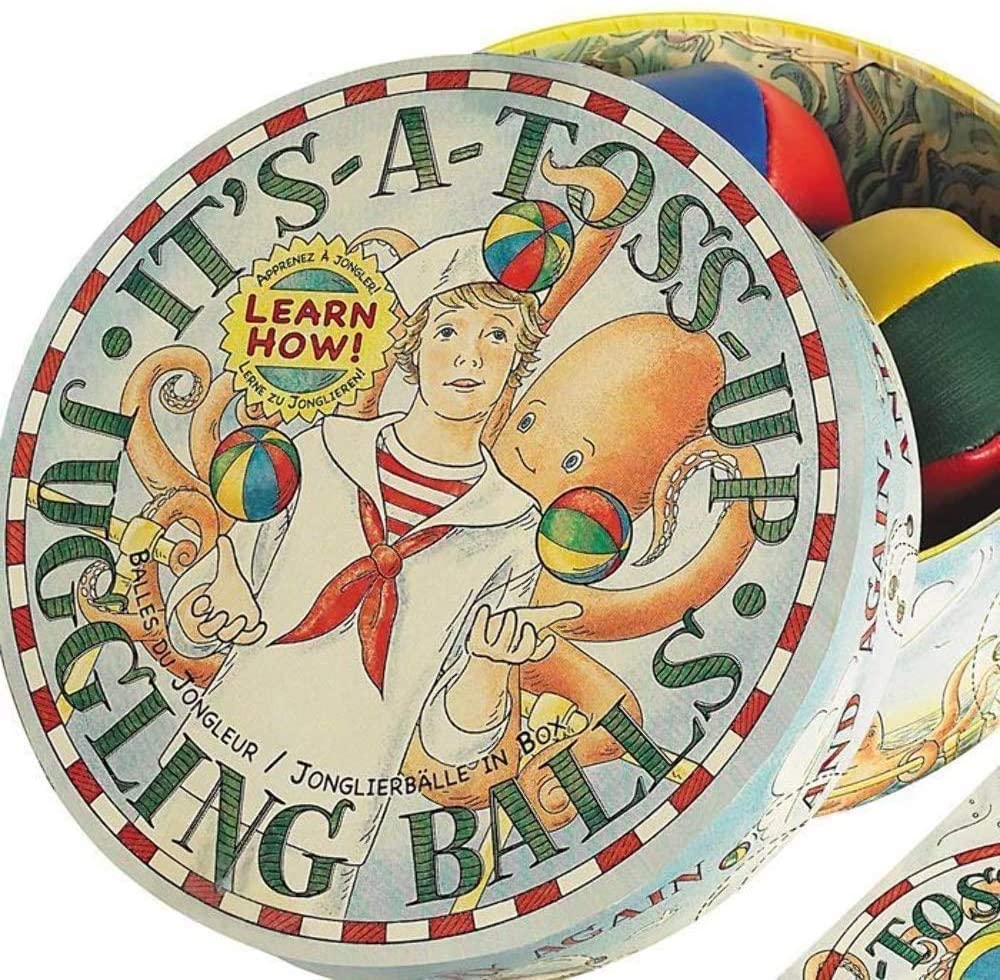 Learn how to juggle. Three juggling balls to toss 'em up using a guide - close up - Austin Gift Shop